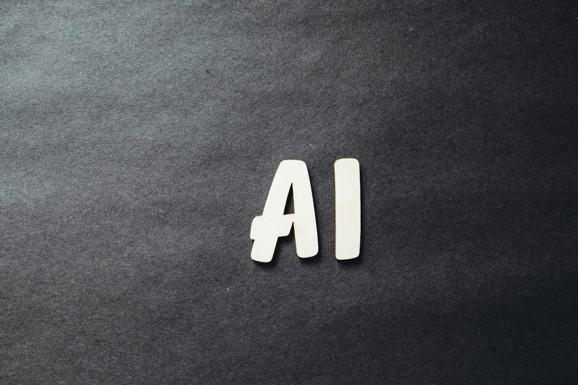 the word ai spelled in white letters on a black surface